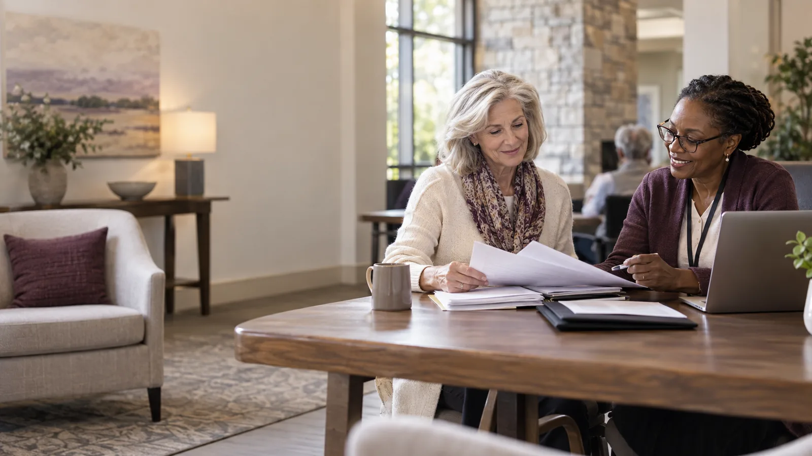 A widow meeting a volunteer tax preparer at a welcoming community tax-help desk with organized records and a secure laptop.