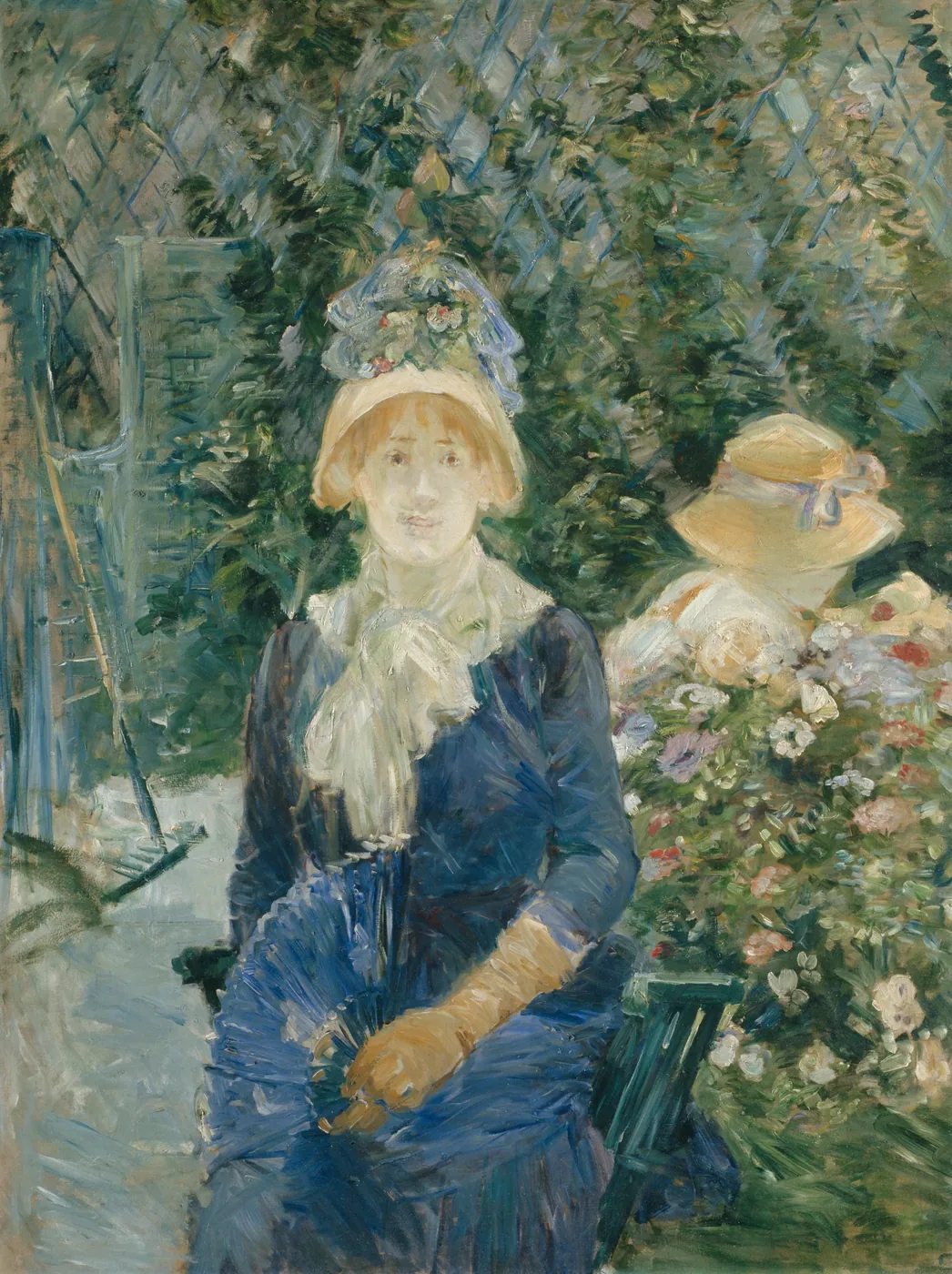 A woman in a dark blue dress, straw bonnet and pale gloves sits composed on a garden bench before a trellis and flowering bushes, with a second figure in a hat beside her.