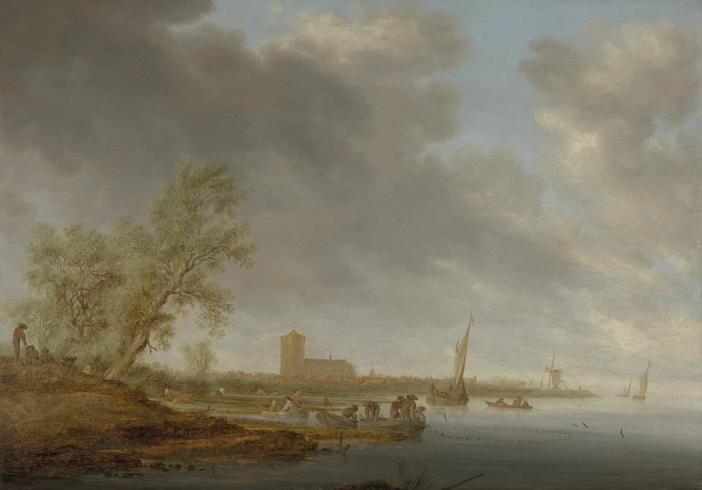Broad calm river under a wide cloudy sky, with fishermen in small boats, sailboats, a distant town and trees on the near bank