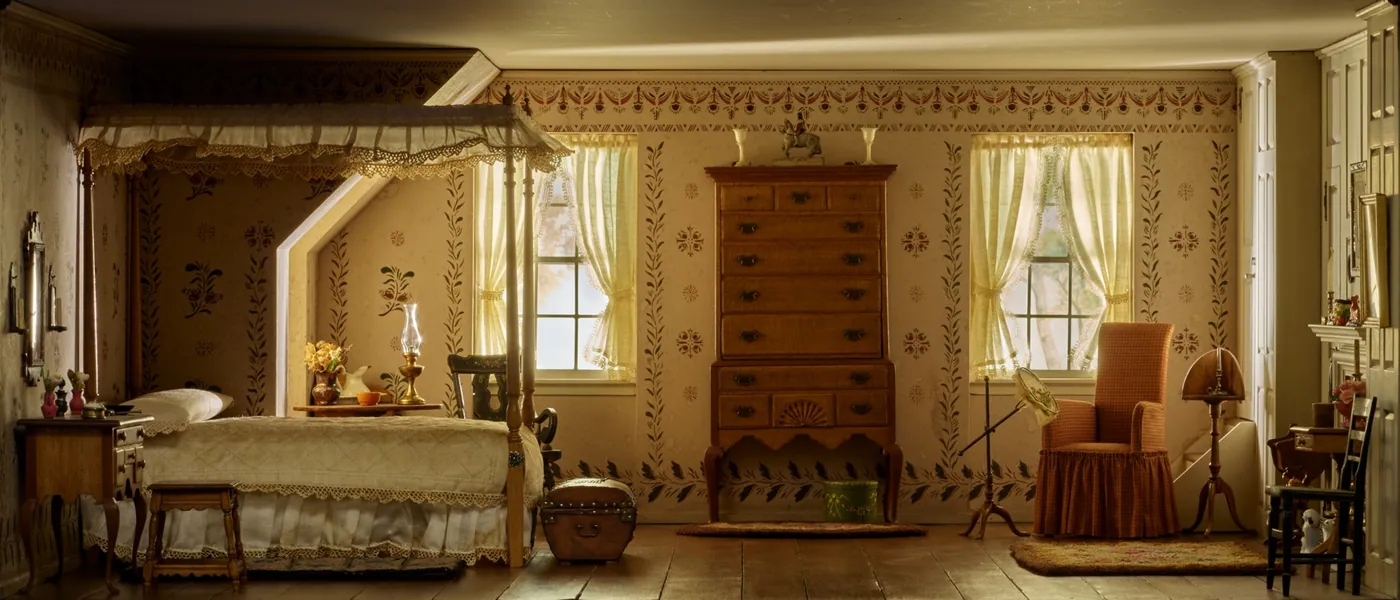 Miniature bedroom with a canopied bed, tall chest of drawers, stencilled walls and two curtained windows in soft light