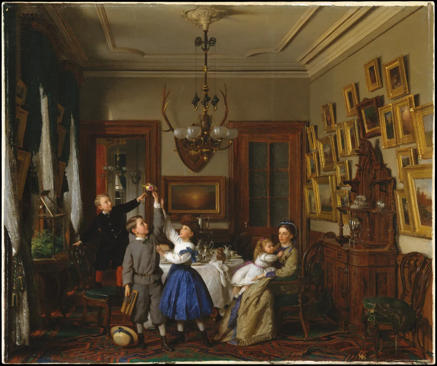 A Victorian dining room hung with gilt-framed paintings: three children reach for a small bouquet while their mother sits holding a toddler.