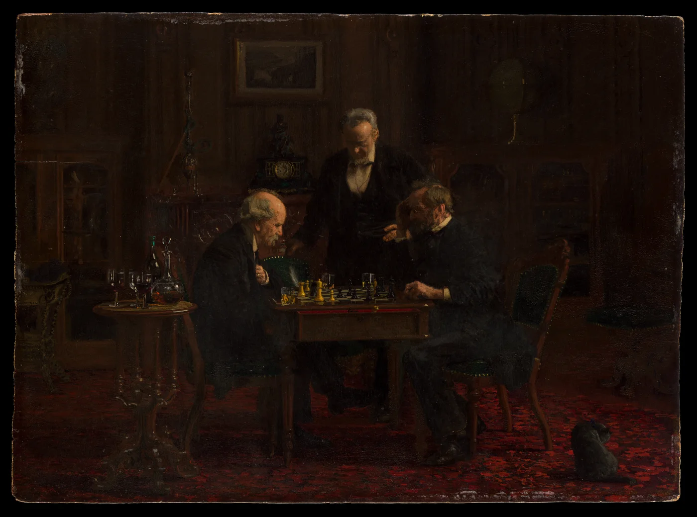 Three men in a dark nineteenth-century room concentrate on a chess game while a small black cat watches from the carpet
